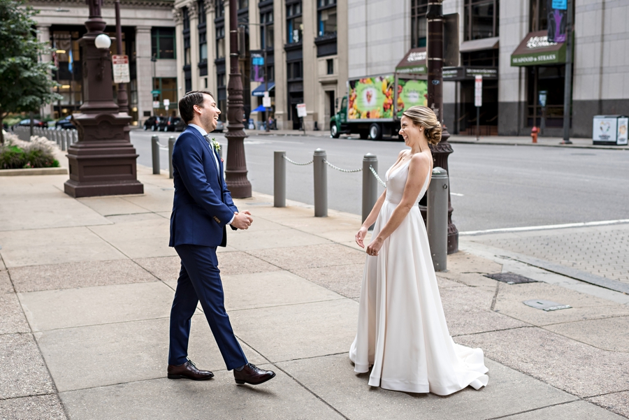 A bride and groom have a first look outside of city hall in Philadelphia.